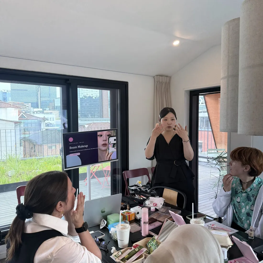 The host opening a Beauty Play session, guests seated around the table