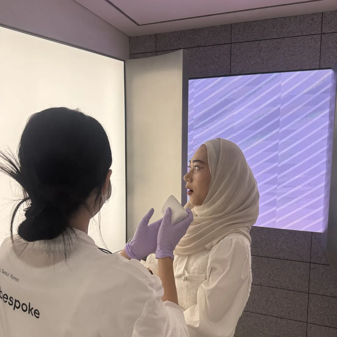 A brand consultant taking an AI skin reading for a guest