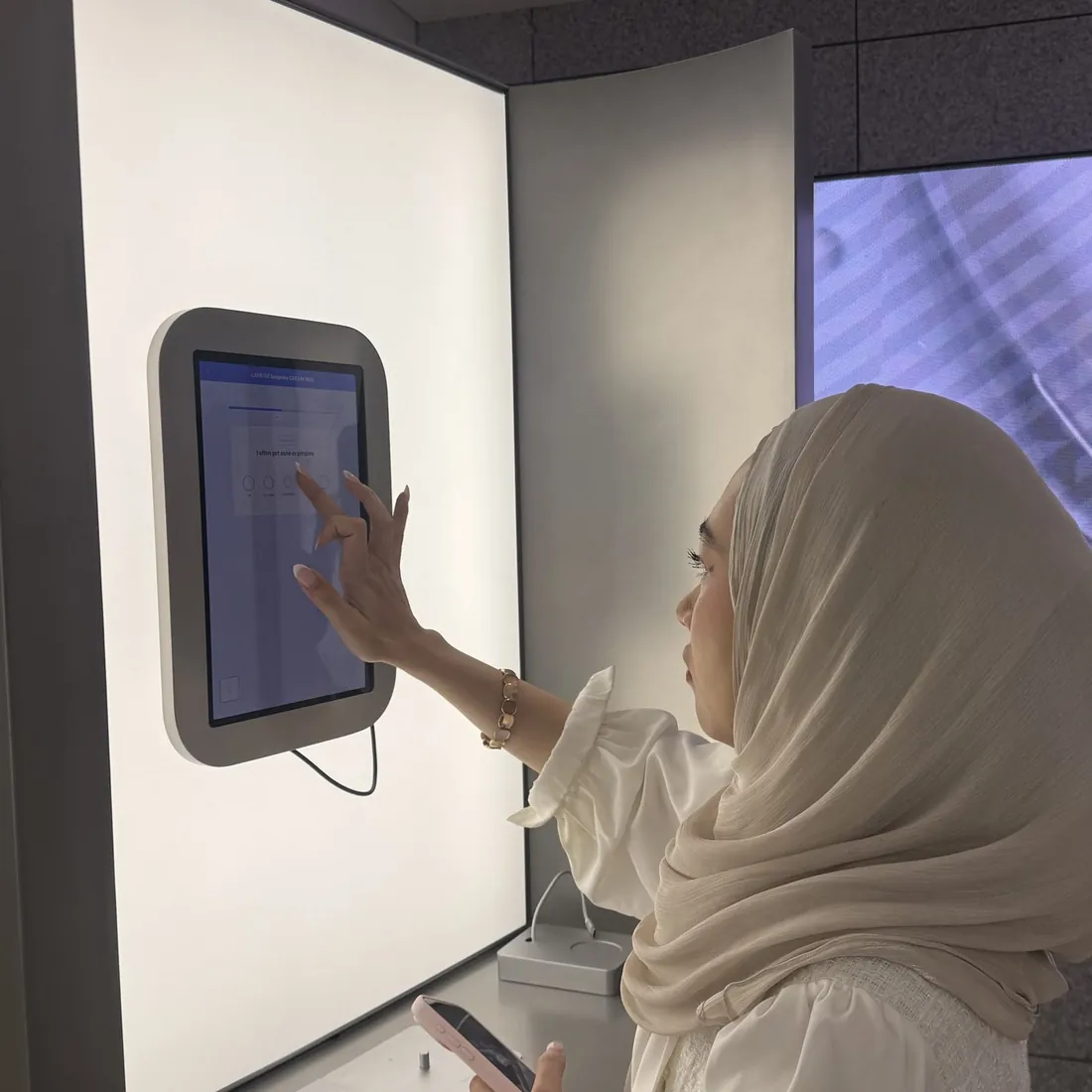 Two guests reading their skin diagnosis results on screen